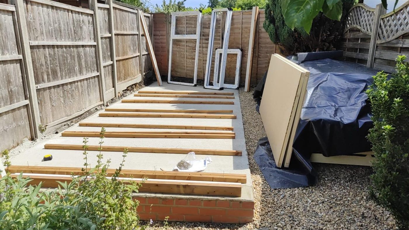 Garden office frame being assembled on the new concrete base in Camberley